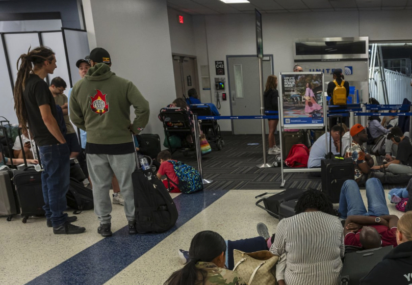Passengers wait at their gate at The Houston Airport